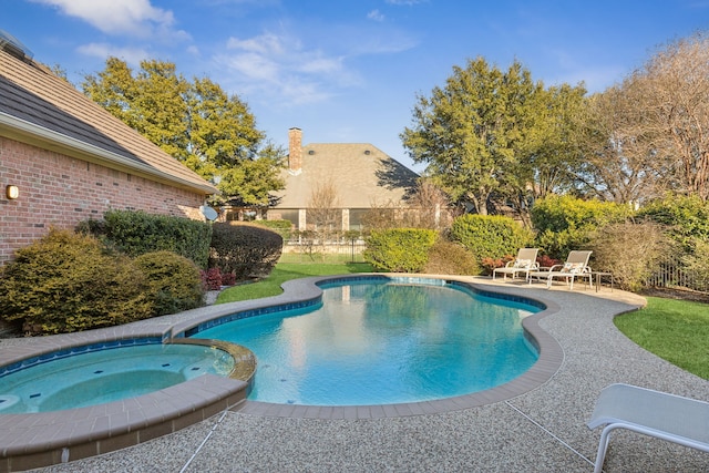 view of swimming pool with a patio area and a pool with connected hot tub