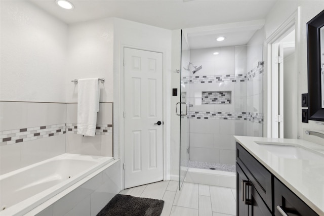 full bath with a garden tub, a shower stall, vanity, and tile patterned floors