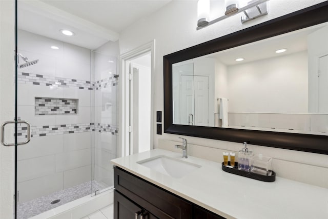 bathroom with recessed lighting, a shower stall, and vanity