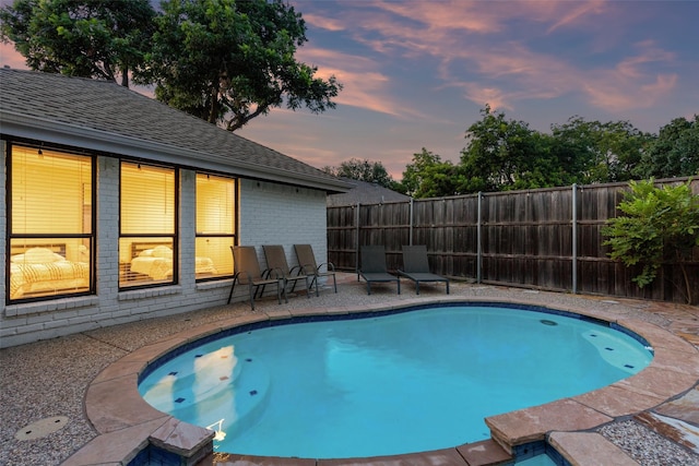 view of pool featuring a patio area and fence