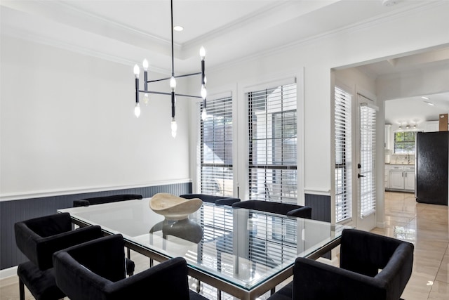 dining area with recessed lighting, a wainscoted wall, ornamental molding, a tray ceiling, and an inviting chandelier