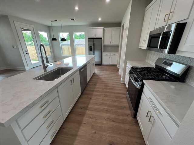 3244 Crites St, Richland Hills, TX 76118 - kitchen with appliances with stainless steel finishes, a sink, recessed lighting, dark wood-type flooring, and white cabinets