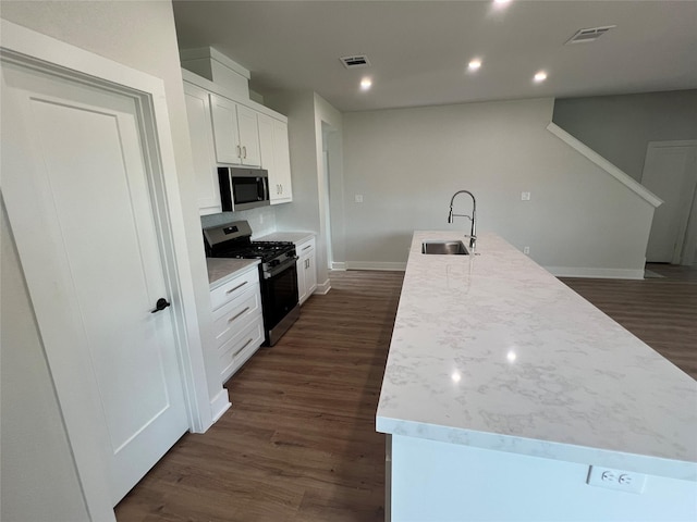 3244 Crites St, Richland Hills, TX 76118 - kitchen with stainless steel appliances, a sink, white cabinetry, baseboards, and dark wood-type flooring