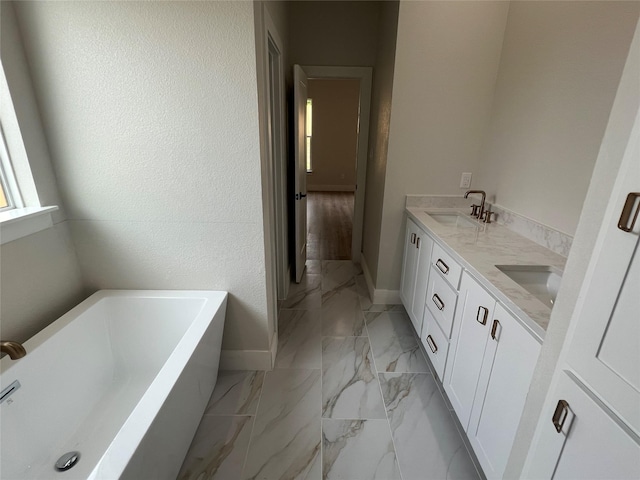 3244 Crites St, Richland Hills, TX 76118 - bathroom with marble look tile flooring, a bath, baseboards, and double vanity