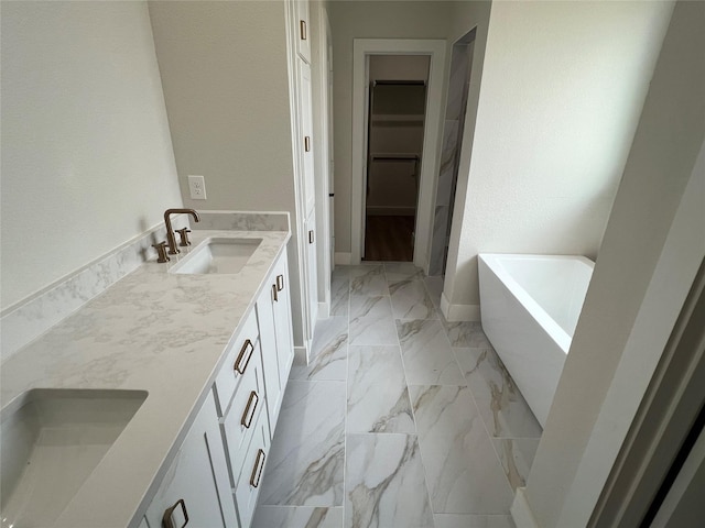 3244 Crites St, Richland Hills, TX 76118 - full bath with a spacious closet, marble look tiles, double vanity, a freestanding tub, and baseboards