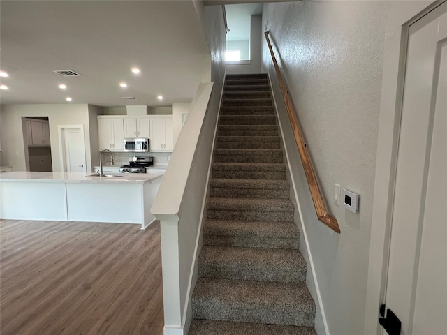 3244 Crites St, Richland Hills, TX 76118 - stairs featuring wood finished floors and recessed lighting