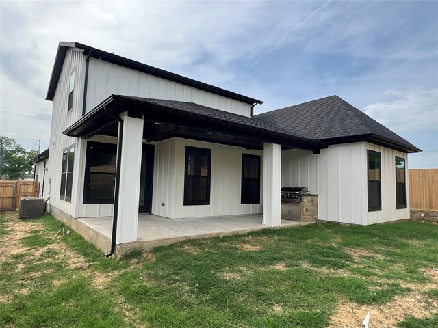 3244 Crites St, Richland Hills, TX 76118 - rear view of property featuring roof with shingles, a patio, an outdoor kitchen, board and batten siding, and central AC unit