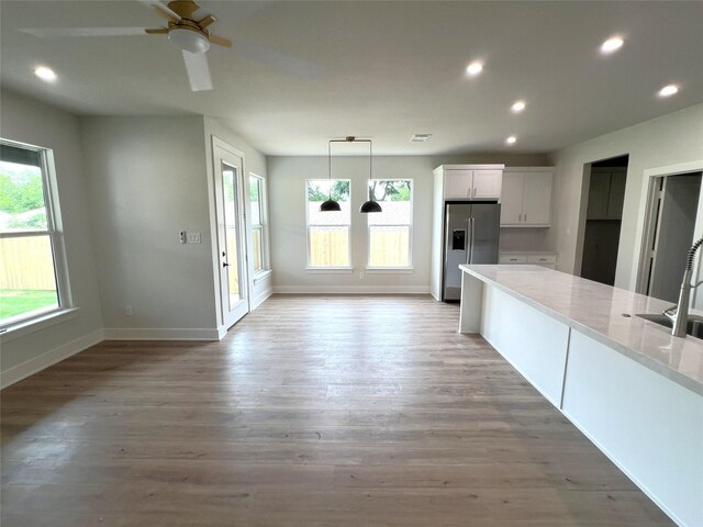 3244 Crites St, Richland Hills, TX 76118 - kitchen featuring stainless steel fridge, baseboards, white cabinetry, recessed lighting, and light wood finished floors