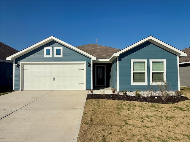 ranch-style home featuring concrete driveway and an attached garage