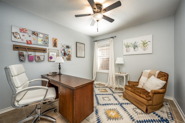 home office with light tile patterned flooring, ceiling fan, and baseboards