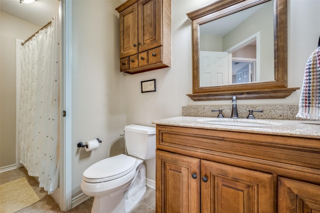 bathroom featuring toilet, curtained shower, vanity, and tile patterned floors