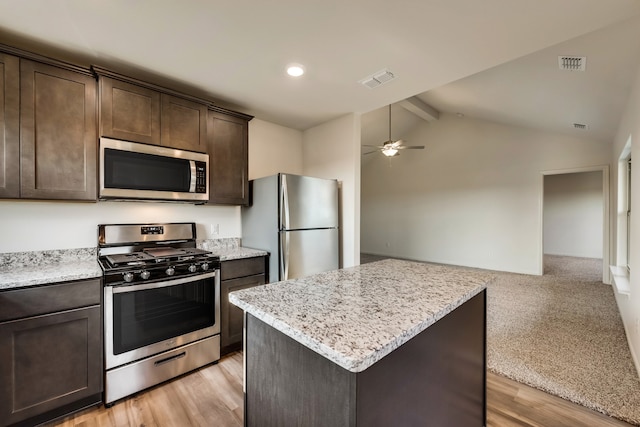 kitchen with vaulted ceiling with beams, ceiling fan, dark brown cabinetry, stainless steel appliances, and light wood-style floors