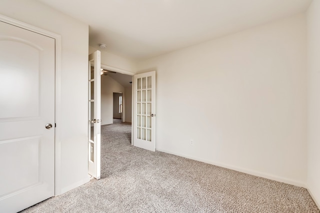 carpeted spare room with french doors