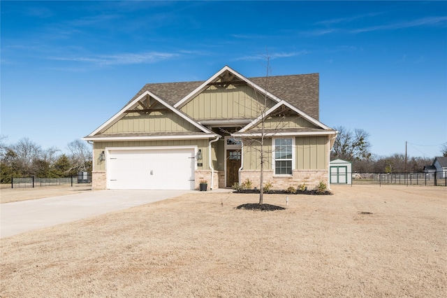 craftsman inspired home with an attached garage, a shingled roof, fence, concrete driveway, and board and batten siding