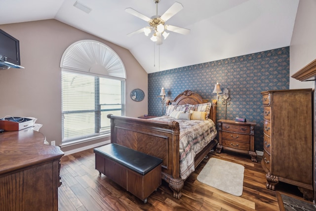 bedroom with wallpapered walls, baseboards, vaulted ceiling, and dark wood finished floors