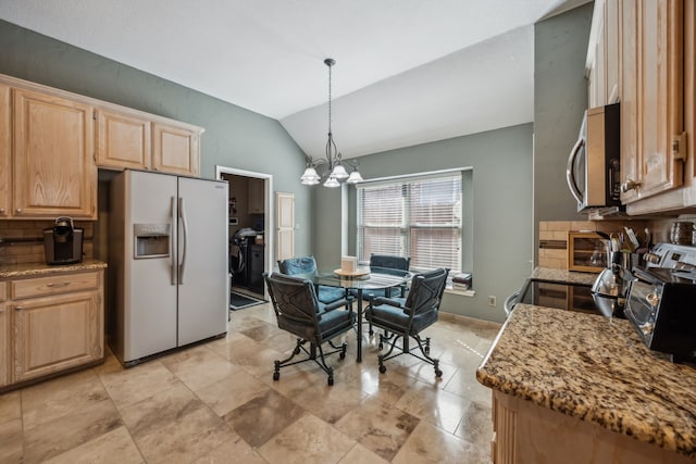 kitchen featuring lofted ceiling, light brown cabinets, white refrigerator with ice dispenser, stainless steel microwave, and an inviting chandelier