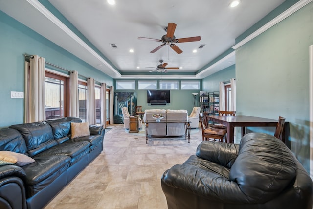 living area with a ceiling fan, recessed lighting, a raised ceiling, and visible vents