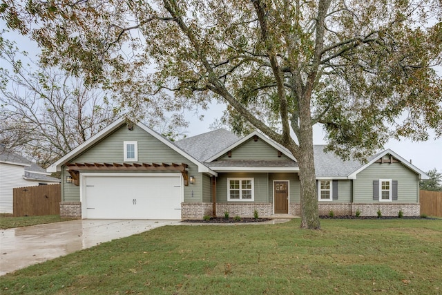 craftsman inspired home with concrete driveway, brick siding, a front yard, and fence