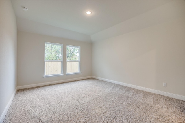 carpeted empty room featuring baseboards