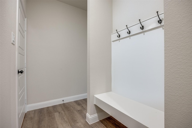 mudroom featuring baseboards and wood finished floors