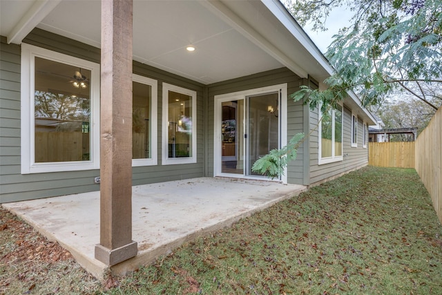 entrance to property with a patio area and fence