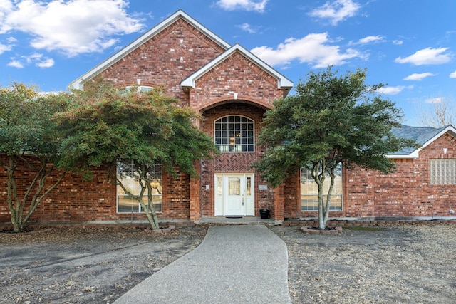 traditional home featuring brick siding