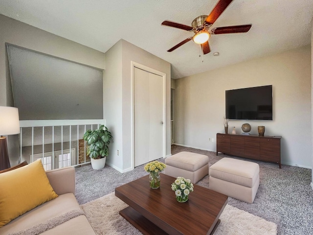 living room featuring carpet floors, baseboards, and a ceiling fan