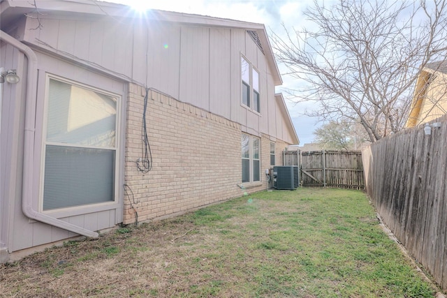 view of yard featuring central AC unit and a fenced backyard