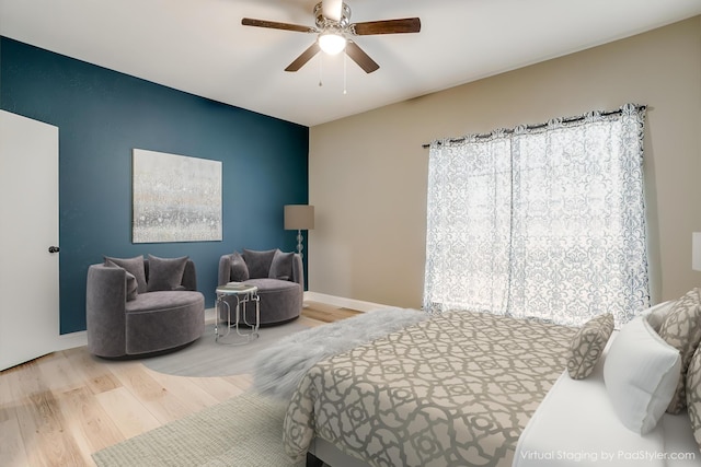 bedroom featuring ceiling fan, baseboards, and wood finished floors