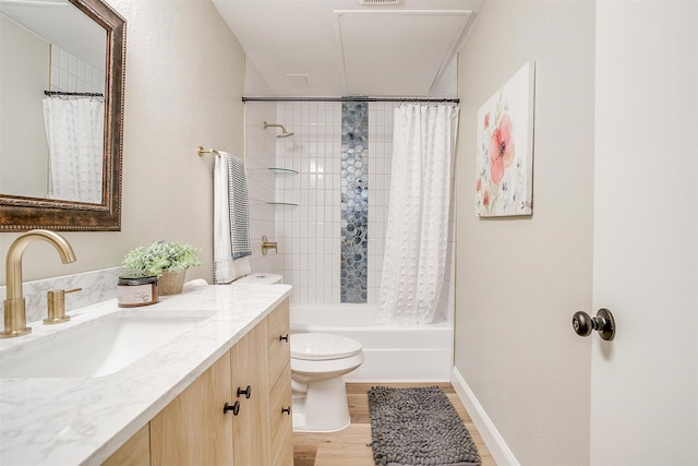 bathroom featuring wood finished floors, vanity, toilet, and shower / bath combo with shower curtain