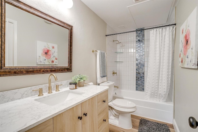 bathroom featuring toilet, shower / bath combo, wood finished floors, and vanity