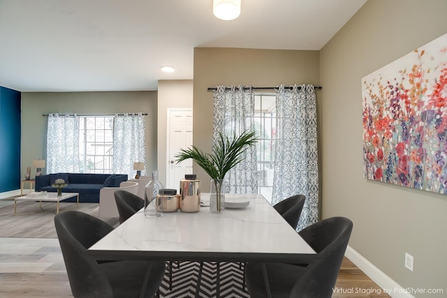 dining space with wood finished floors and baseboards