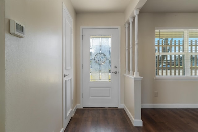 entryway with dark wood-style floors and baseboards