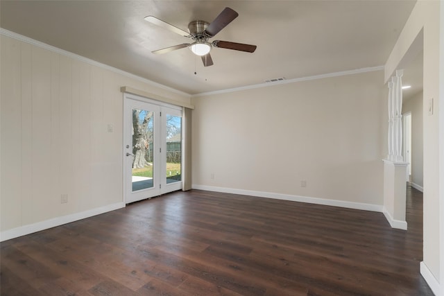 empty room featuring ornamental molding, dark wood-type flooring, visible vents, and baseboards