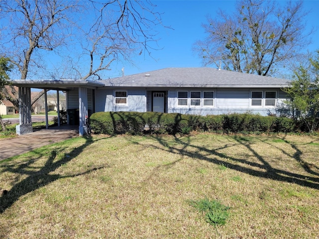 single story home with driveway, a front lawn, an attached carport, and brick siding