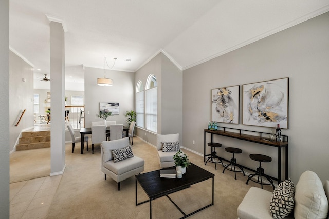 living room with crown molding, light tile patterned floors, baseboards, and ceiling fan