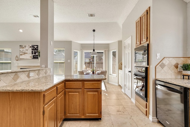 kitchen featuring visible vents, dishwashing machine, light stone counters, stainless steel microwave, and oven