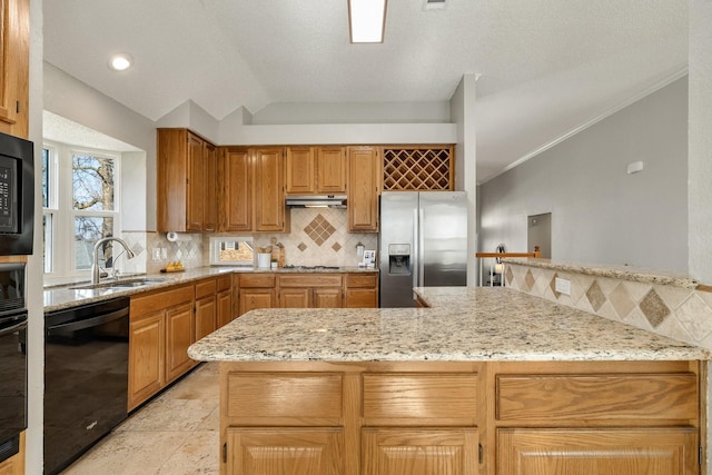 kitchen with a sink, vaulted ceiling, decorative backsplash, light stone countertops, and black appliances