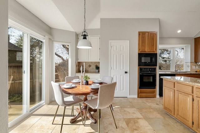 dining space with vaulted ceiling, recessed lighting, and baseboards