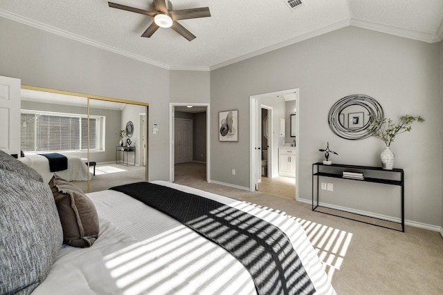 carpeted bedroom with crown molding, a closet, visible vents, vaulted ceiling, and baseboards