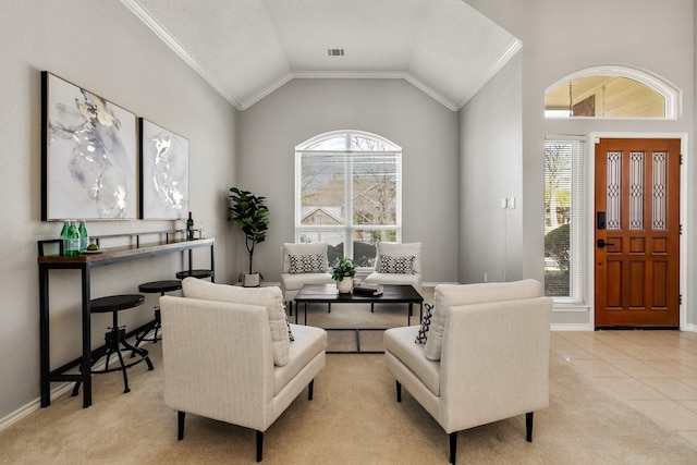 carpeted living room with tile patterned flooring, visible vents, baseboards, vaulted ceiling, and ornamental molding