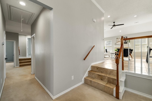 stairway with carpet floors, attic access, and baseboards