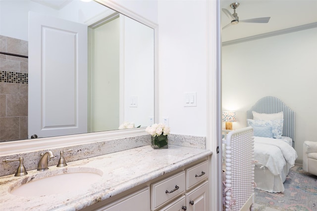 ensuite bathroom with ceiling fan, connected bathroom, and vanity