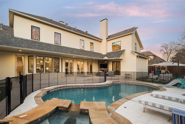 view of pool featuring a fenced in pool, an in ground hot tub, a patio, and fence