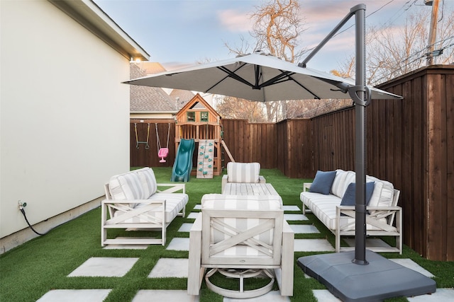 view of patio with a playground, a fenced backyard, and an outdoor living space