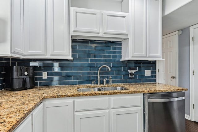 kitchen with a sink, white cabinetry, and dishwasher