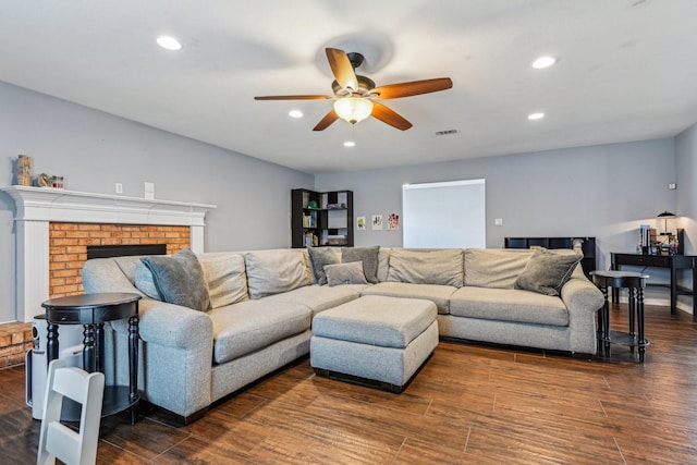 living area featuring visible vents, dark wood finished floors, a ceiling fan, a fireplace, and recessed lighting