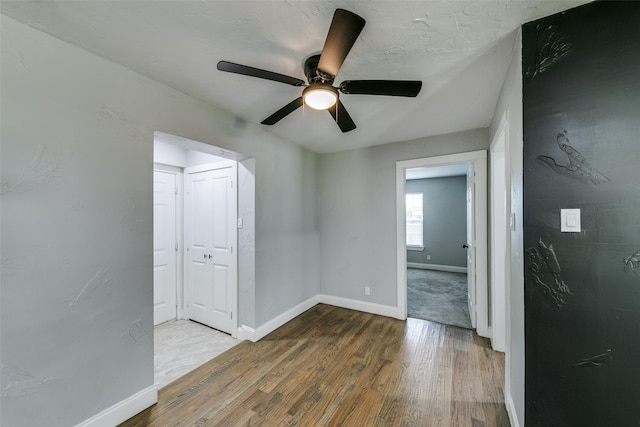 empty room featuring baseboards and wood finished floors