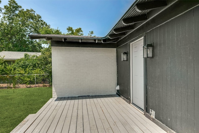 deck featuring a lawn and fence
