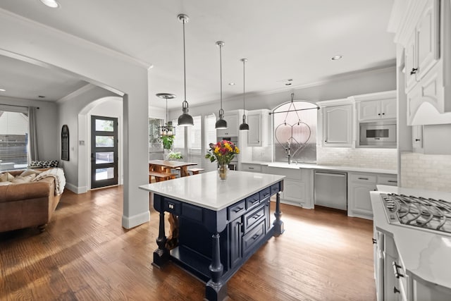 kitchen with built in microwave, white cabinets, stainless steel dishwasher, light wood-type flooring, and decorative backsplash